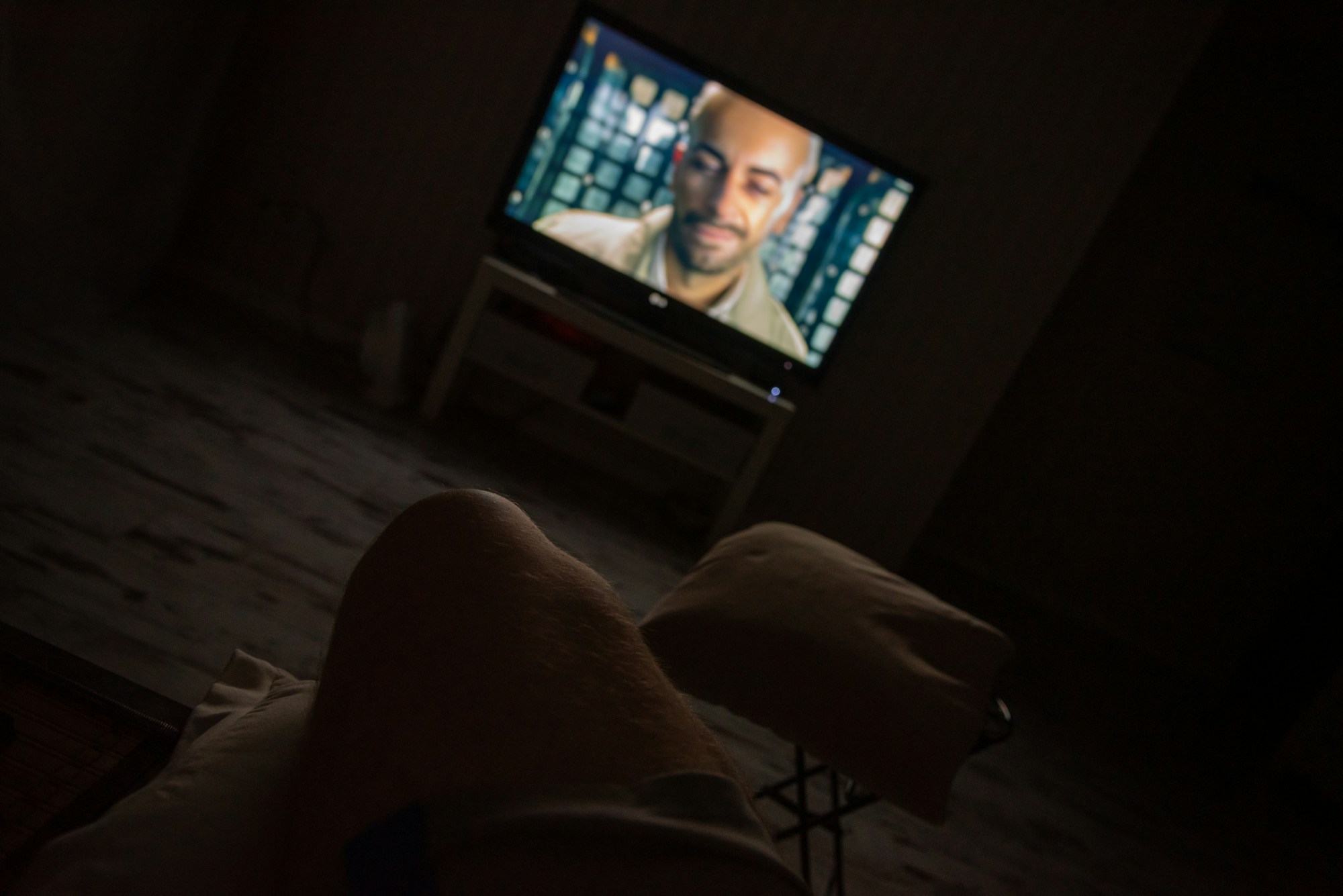 Watching live TV streaming at home in a dark living room